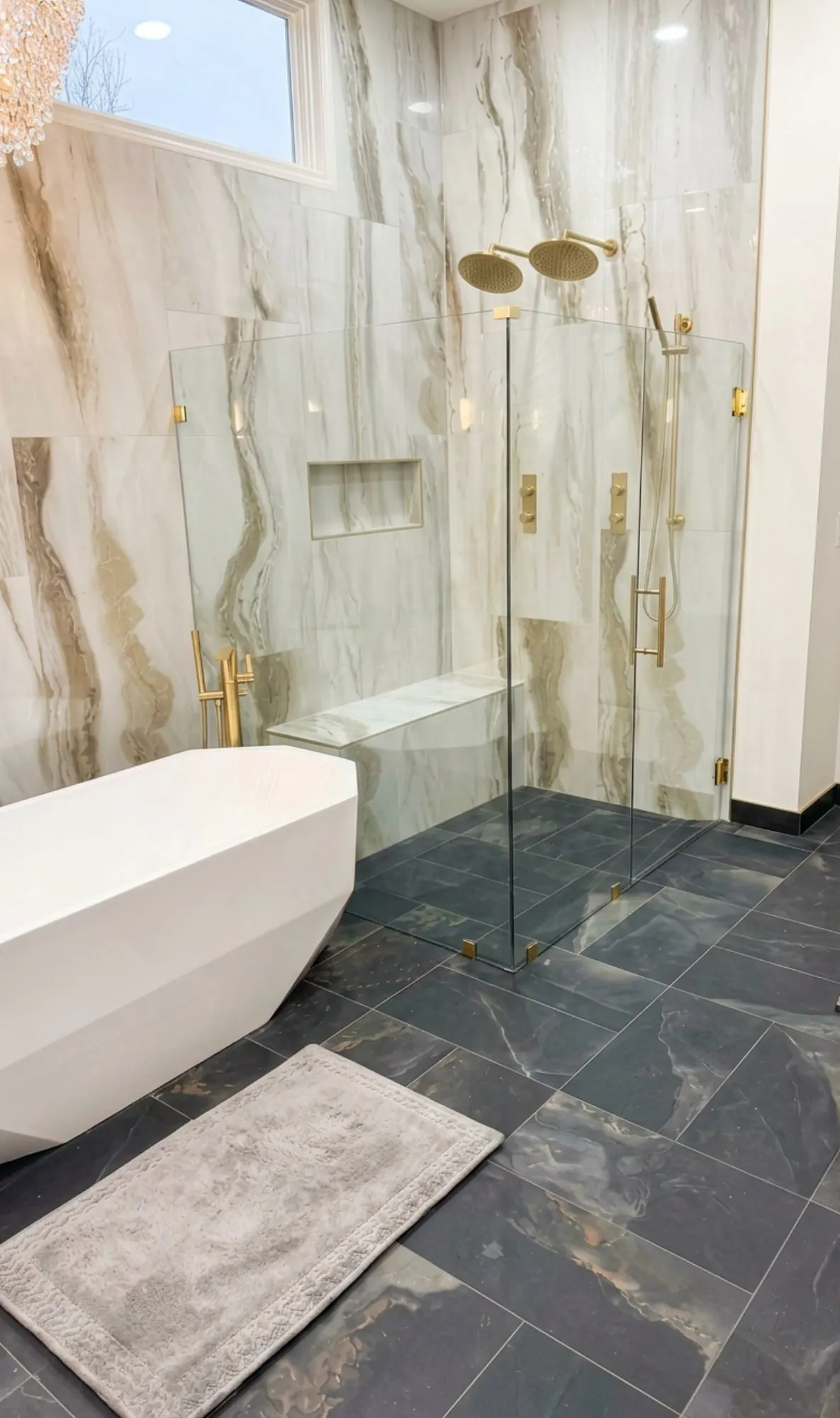 Primary bathroom remodel in Shawnee, KS with dark botanical wallpaper and brass sconces