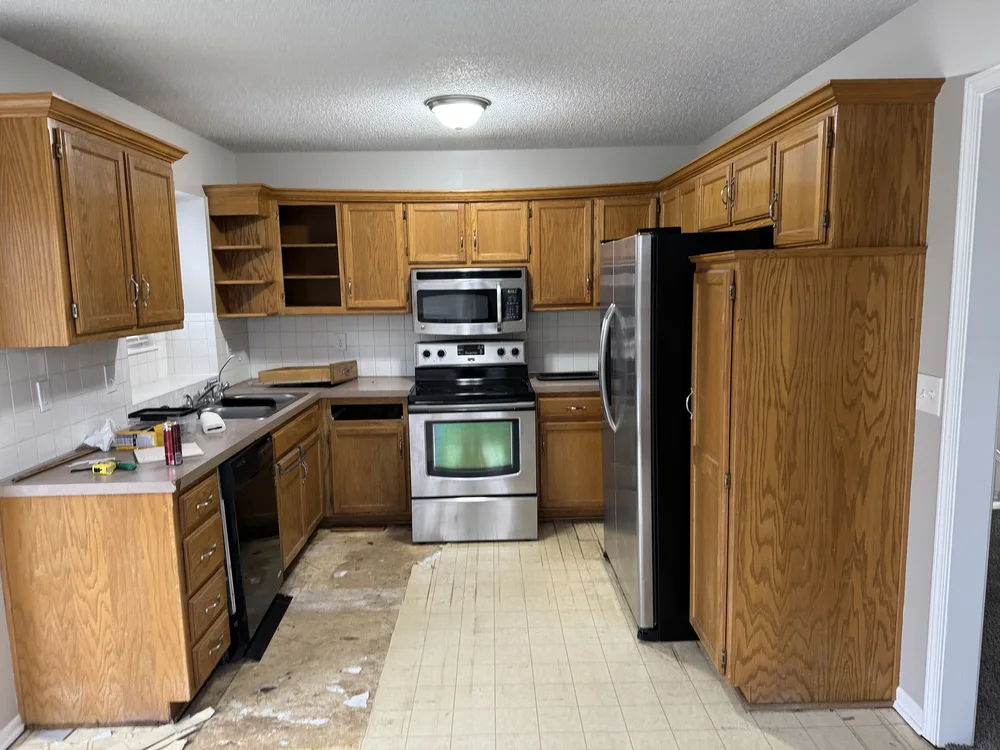 Kitchen remodel in Blue Springs, MO before renovation with original oak cabinetry and damaged ceiling