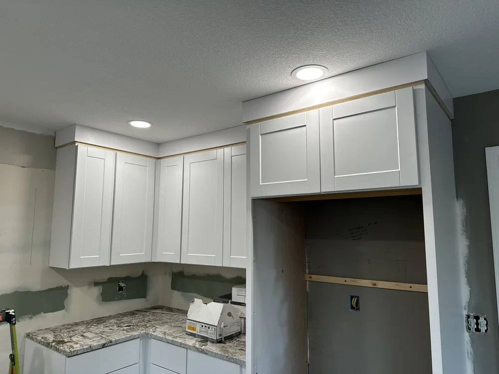 Kitchen remodel in Blue Springs, MO — new white cabinetry installed with recessed lighting