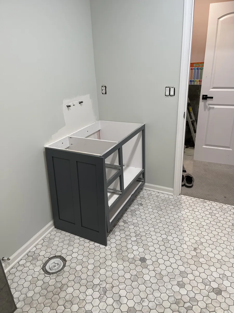 Bathroom remodel in Kansas City, MO — custom vanity cabinet being installed