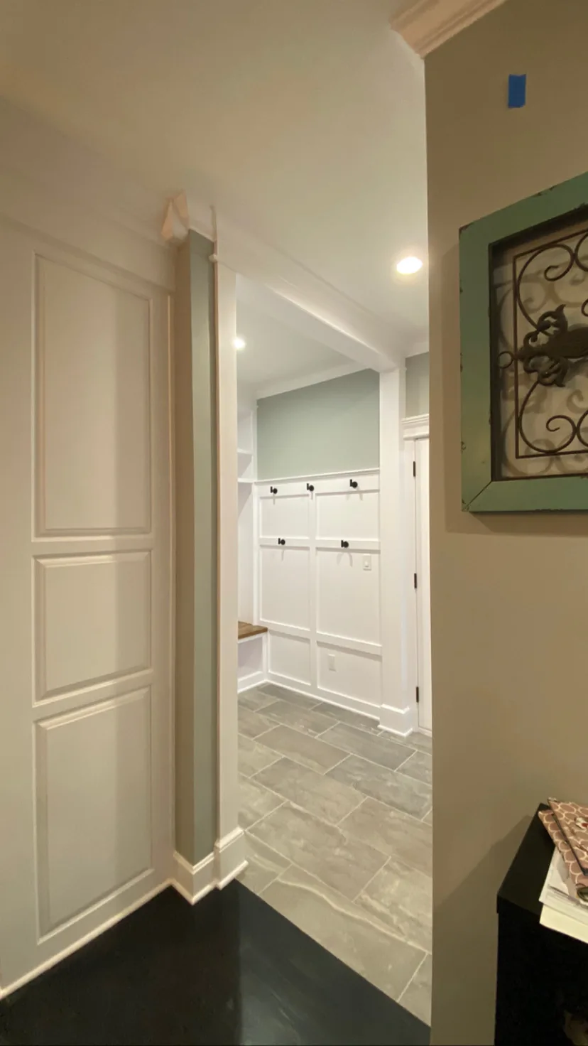 Mudroom remodel in Kansas City, MO seen from the hall through the new cased opening, with the ceiling running through at full height