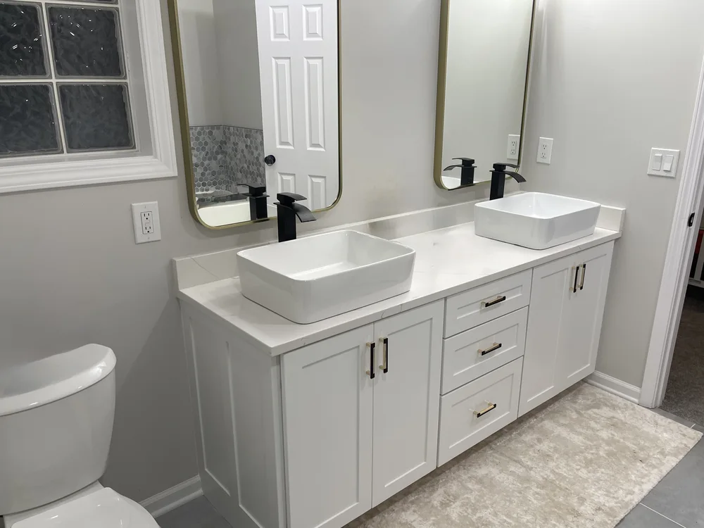 Whole-home remodel in North Kansas City, MO — custom double vanity with vessel sinks and brass hardware