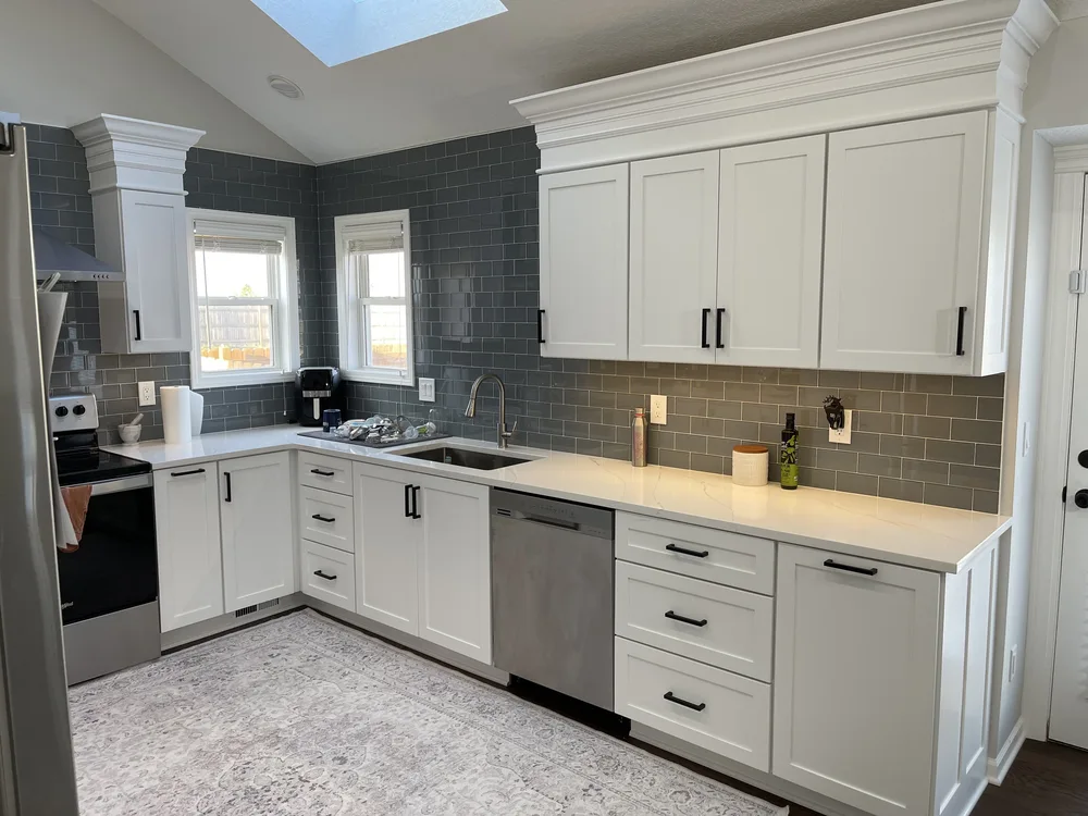 Whole-home remodel in North Kansas City, MO — finished kitchen fully styled with appliances and rug