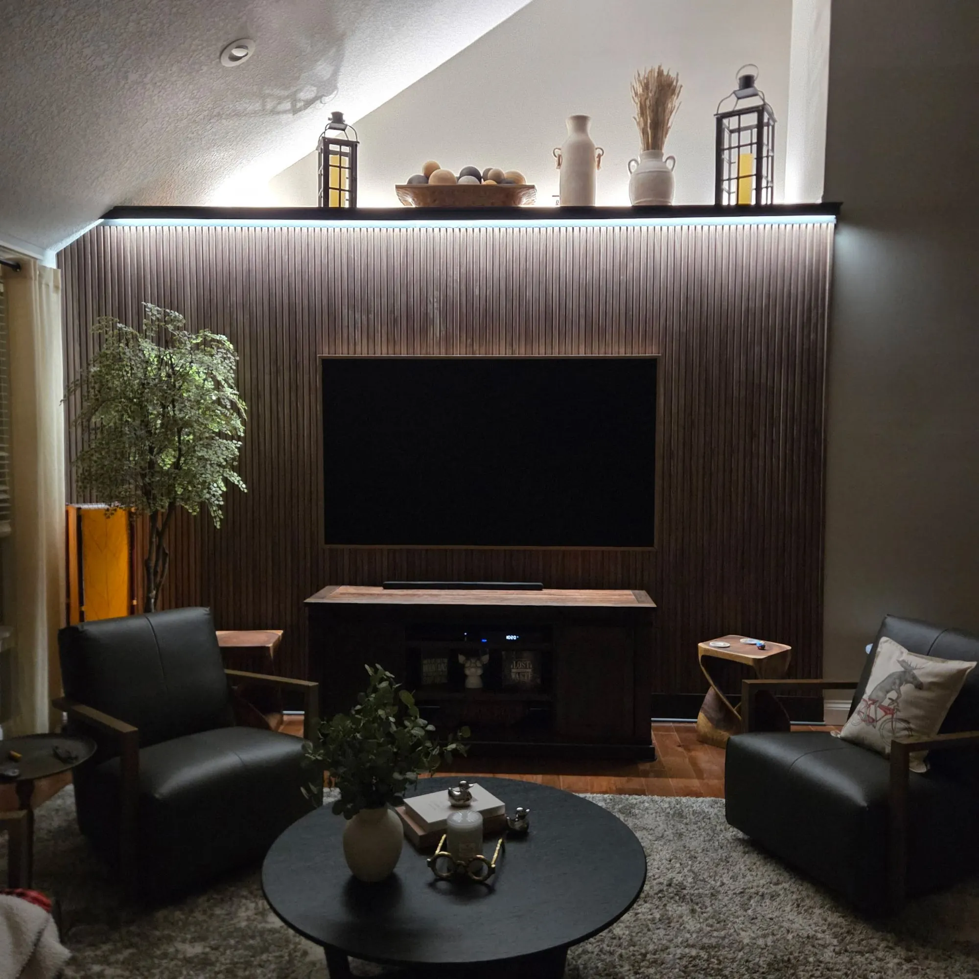 Living room remodel in Olathe, KS with fluted wood accent wall, built-in media wall, and backlit display shelf
